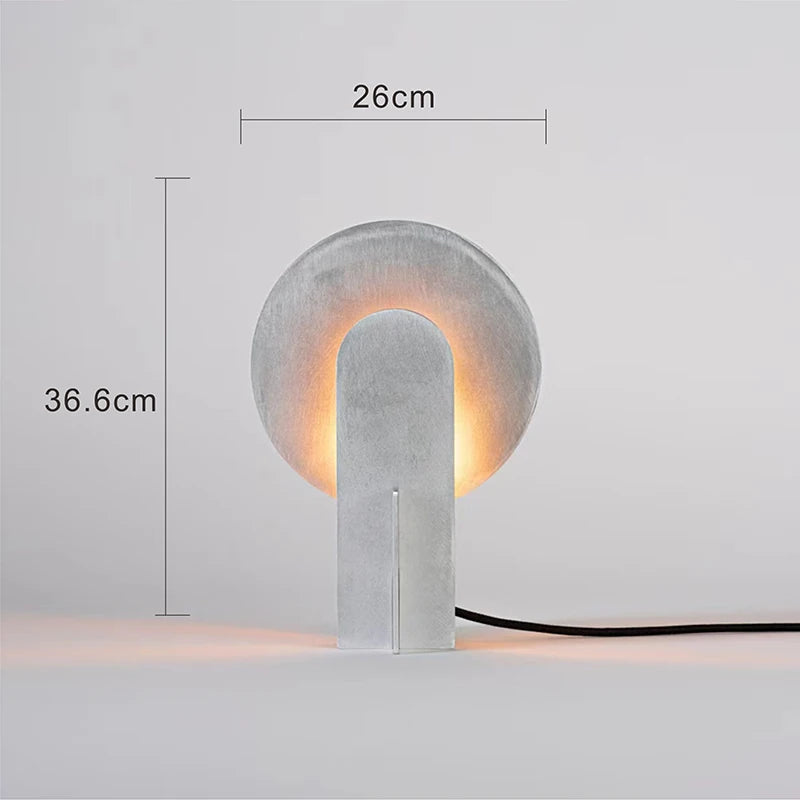 Concrete table lamp with dimensions indicated on a light gray background