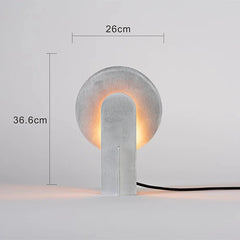 Concrete table lamp with dimensions indicated on a light gray background