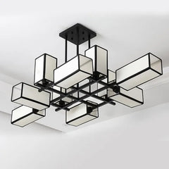 Black geometric semi-flush ceiling light with fabric shades, angled view.