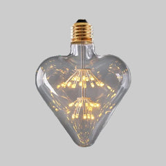 Heart-shaped LED light bulb on a gray background