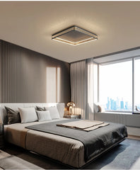 Modern bedroom with a bed, lamp, and large window.