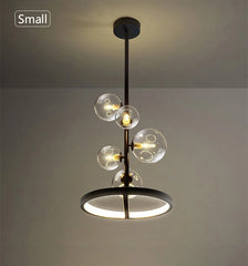 Modern pendant light with three glass bulbs on a neutral background