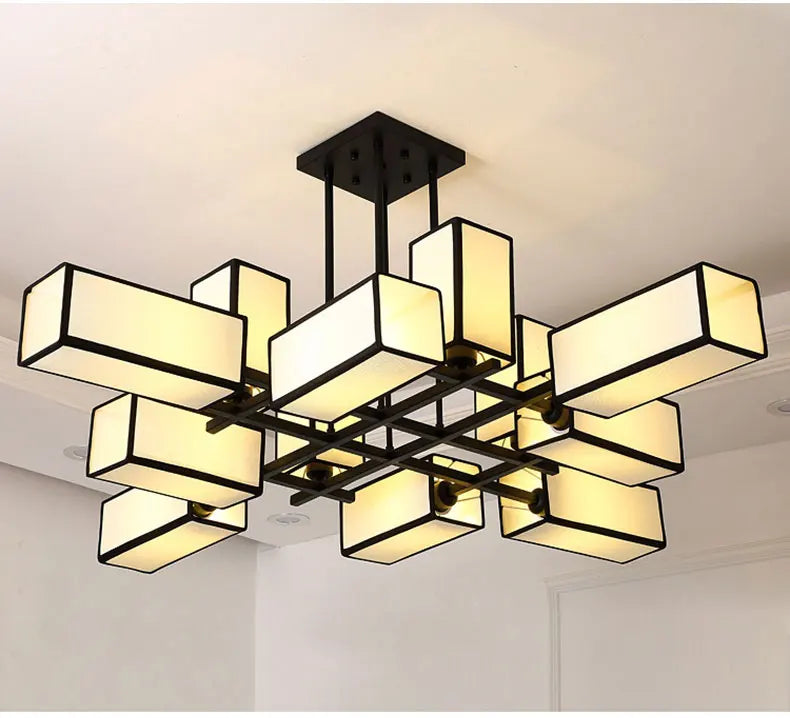 Black geometric semi-flush ceiling light with fabric shades, viewed from below.