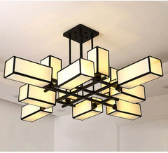 Black geometric semi-flush ceiling light with fabric shades, viewed from below.