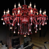 A large, ornate red crystal chandelier with multiple candle-style arms and cascading teardrop crystals against a black background.