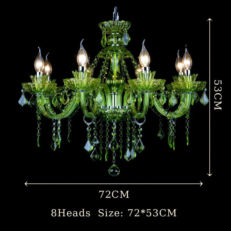 A close-up view of the intricate red crystal detailing on a chandelier arm, showing faceted crystals and candle-shaped bulb holders.