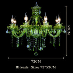 A close-up view of the intricate red crystal detailing on a chandelier arm, showing faceted crystals and candle-shaped bulb holders.