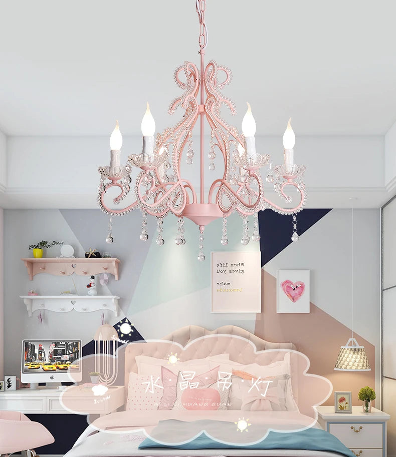 Pink chandelier with crystal details hanging in a bedroom with pastel geometric wall art and a light-colored bed
