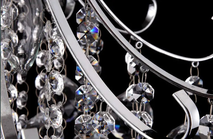 Close-up of a chandelier with crystal details on a black background