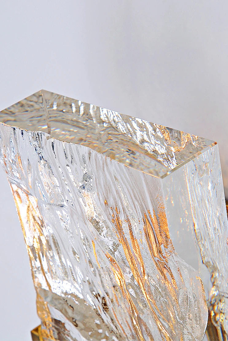Crystal-like structure with gold veins on a light gray background
