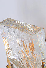 Crystal-like structure with gold veins on a light gray background