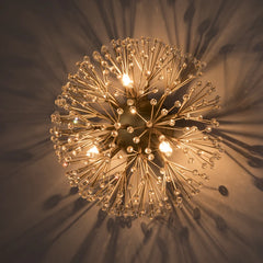 Decorative ceiling light fixture with a starburst design on a dark background