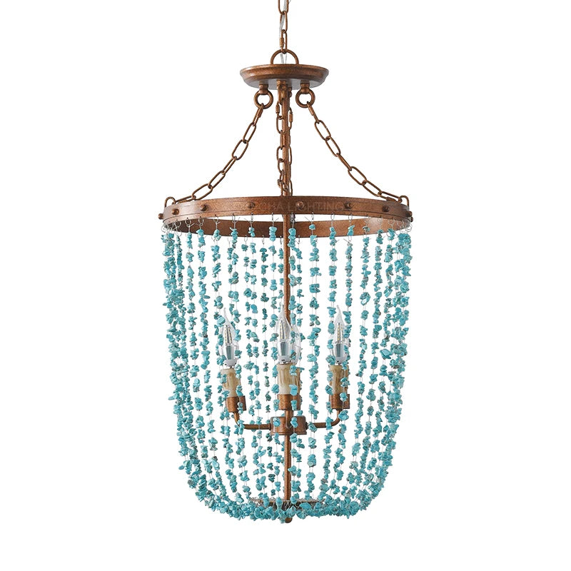 Turquoise stone bead chandelier with a distressed gold frame and three visible bulbs, isolated on a white background.