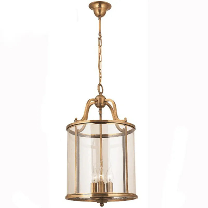 Close-up of a medium brass cylinder glass chain pendant light against a white background