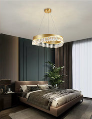 Modern bedroom with a chandelier, bed, and decor elements.