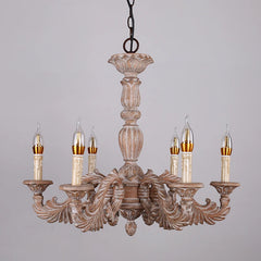 A distressed wood candelabra chandelier with multiple arms and candle-shaped lights, showcasing its ornate carvings and rustic finish.