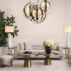 Modern living room with a chandelier, sofa, and decorative elements.