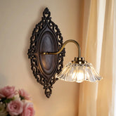 Decorative wall sconce with floral arrangement in the foreground