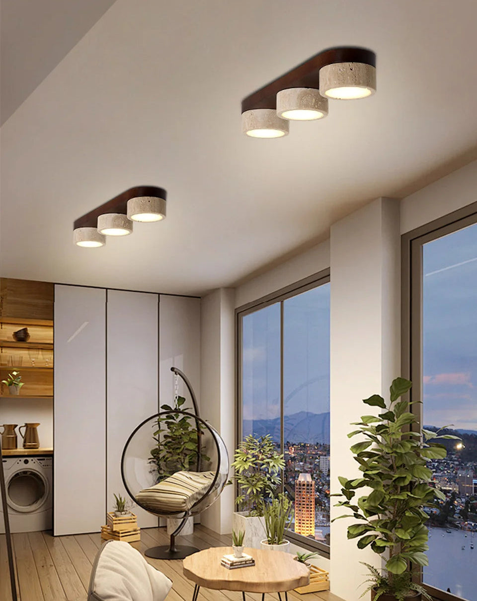 Modern living room with ceiling lights, a hanging chair, and cityscape view.