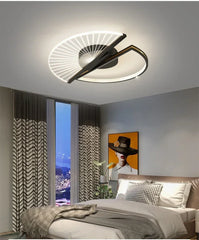 Close-up of a circular LED ceiling light with a fan-like design and black frame.
