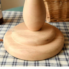 Wooden pepper grinder on a checkered tablecloth