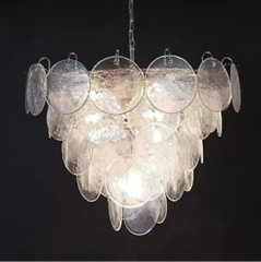 Chandelier with circular glass panels on a black background
