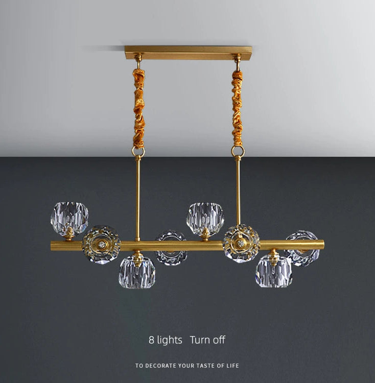 Gold chandelier with crystal shades on a gray background
