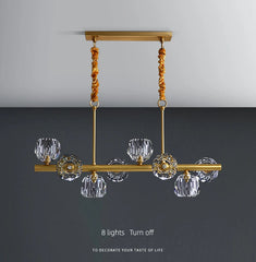 Gold chandelier with crystal shades on a gray background