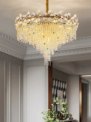 Close-up view of the gold frame and intricate crystal detailing on a petal-shaped chandelier, showcasing the craftsmanship.