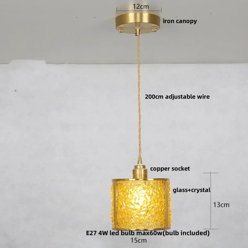 Gold pendant light with measurements and details on a white background