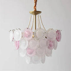Chandelier with pink and clear glass shades on a light gray background