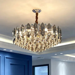 A detail of the light source within the crystal chandelier, showing the faceted crystal pieces reflecting the warm LED light.