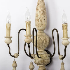 Vintage-style chandelier with wooden candle holders against a white background