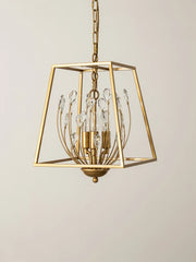 A detail shot of a gold metal cage pendant light, focusing on the arrangement of clear teardrop crystals and the central light bulbs.