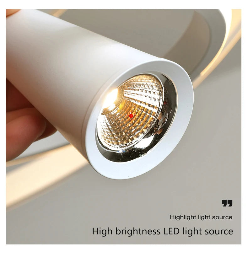 Close-up of a high brightness LED light source with a hand holding it, on a neutral background.