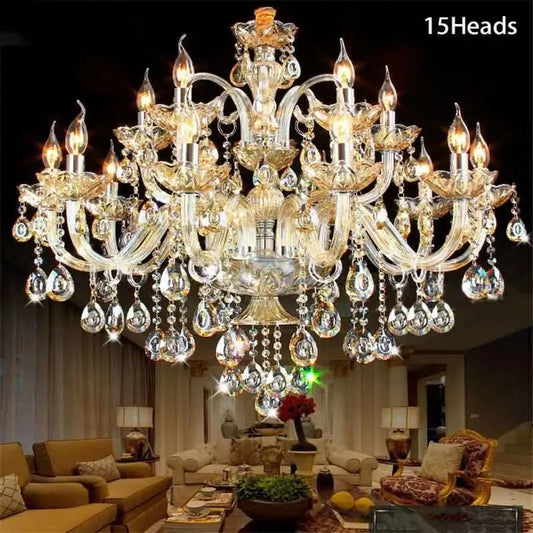 An elegant 12-arm gold crystal candelabra chandelier displayed in a hotel lobby with a grand staircase.