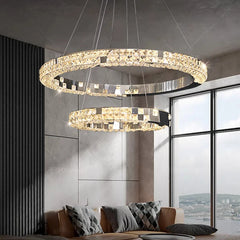 Modern chandelier with two circular rings in a living room setting.