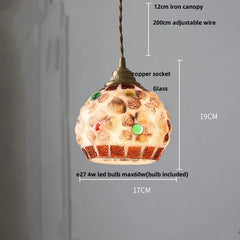 Decorative pendant light with measurements on a gray background