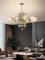 Modern chandelier hanging in a living room with gray walls and furniture.