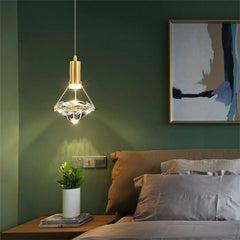 Modern bedroom with a hanging pendant light, bed, and wall art.