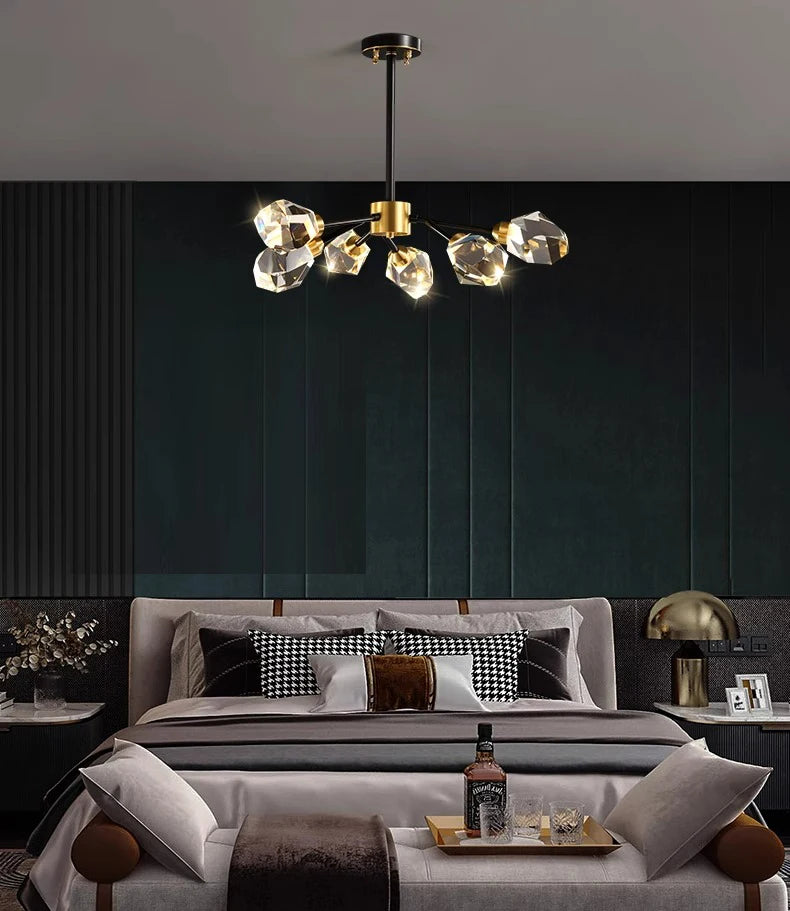 Modern bedroom with a stylish chandelier, bed, and decor.