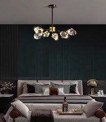 Modern bedroom with a stylish chandelier, bed, and decor.