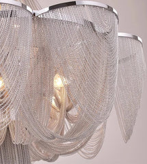 Close-up of a chandelier with crystal strands on a neutral background