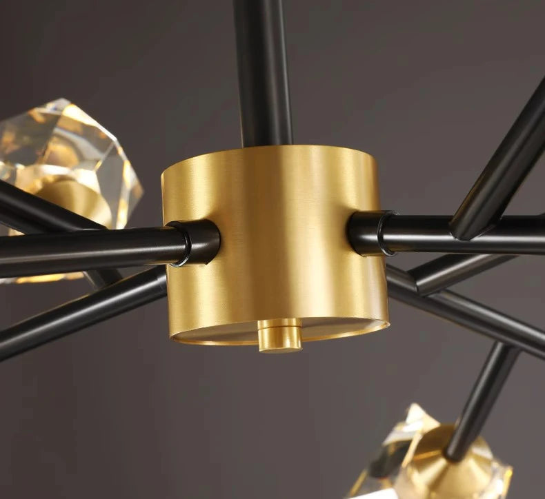 Close-up of a chandelier with gold and black design on a dark background