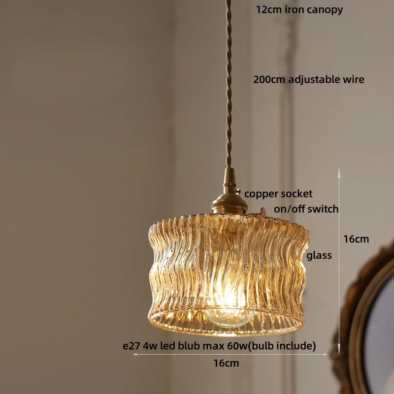 Gold pendant light with measurements and details on a neutral background