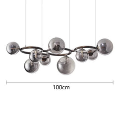 Chandelier with spherical glass shades and measurement label on a white background