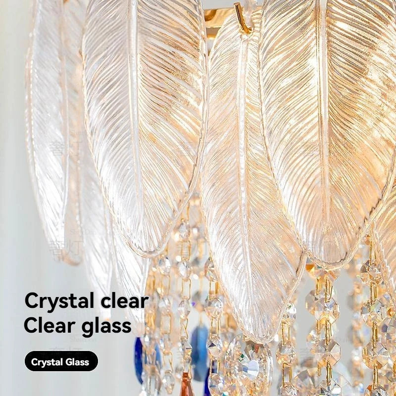 Crystal clear glass chandelier with gold accents on a white background