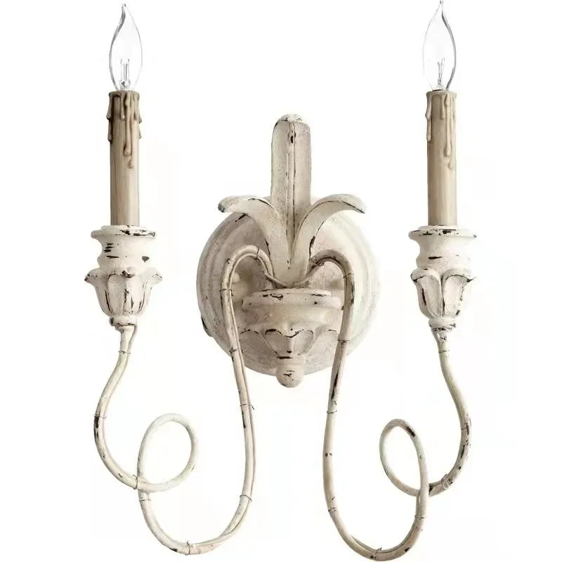Decorative wall sconce with two candle-style lights on a white background