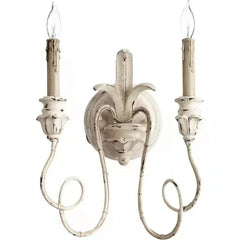 Decorative wall sconce with two candle-style lights on a white background