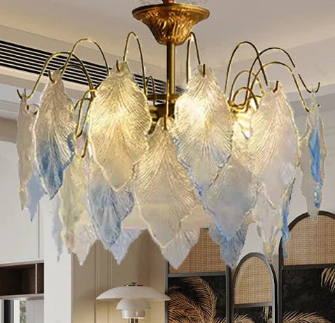 Decorative chandelier hanging in a living room with a brown sofa and wall art.